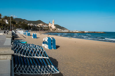  view of the empty beach in sitges during tourist season, a spanish beach resort in catalonia, spain