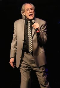 Full length of a man standing against black background