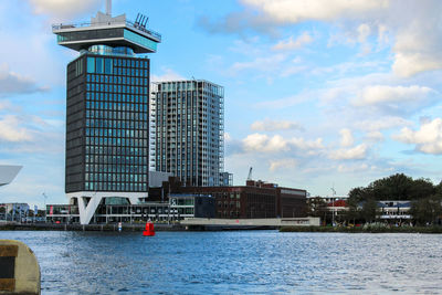 Ship moored in city against sky