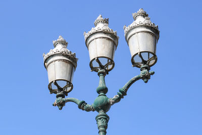 Low angle view of street light against clear blue sky