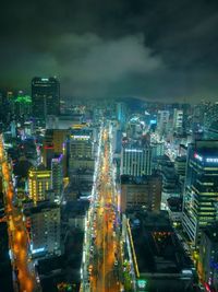 High angle view of city lit up at night