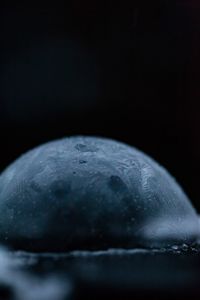 Close-up of water drop on black background