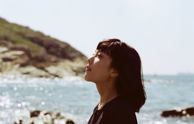 Side view portrait of young woman looking away