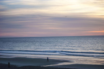 Scenic view of sea against sky at sunset