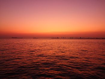 Scenic view of sea against orange sky