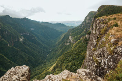 Scenic view of valley and mountains against sky