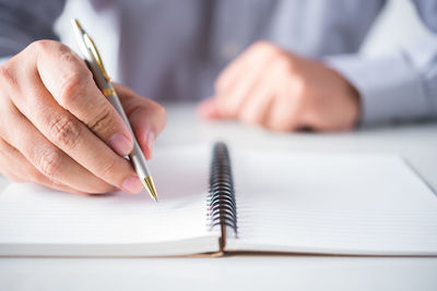 Close-up of hand holding book