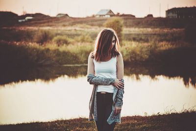 Woman standing by lake