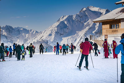 People skiing on snowcapped mountain