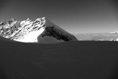 Scenic view of snow covered mountains against sky