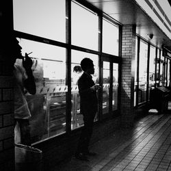 Full length of woman standing by railing