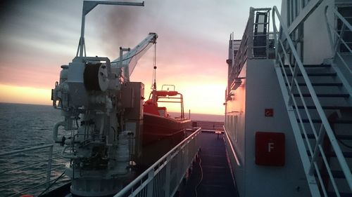 Panoramic view of factory against sky during sunset