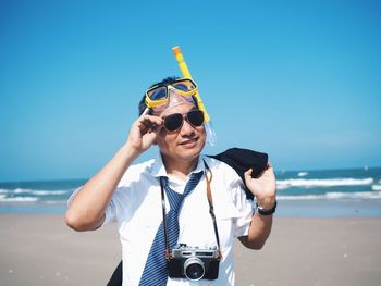 Portrait of smiling young man on beach