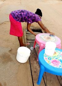 High angle view of girl sitting on land