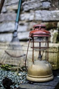 Close-up of lantern on table in yard