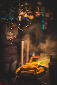 Sweetcorns in container at night