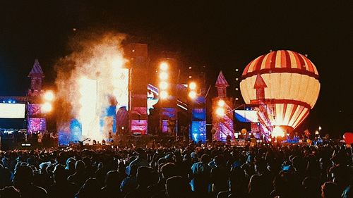 Group of people in illuminated building at night