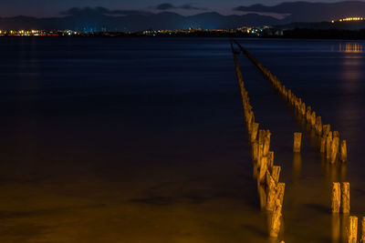 High angle view of wooden posts in lake