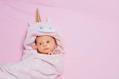 Portrait of cute baby girl against white background