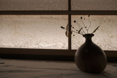 Close-up of vase on window sill