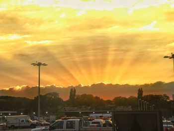 Silhouette city against sky during sunset