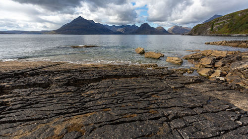 Scenic view of sea and mountains against sky