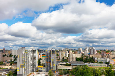 An urban landscape with high and low architecture under a beautiful dramatic sky with thick clouds.