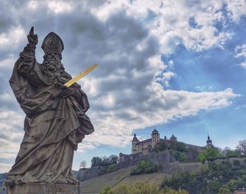 Low angle view of statue against cloudy sky