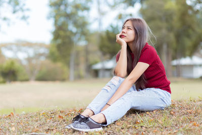 Young woman sitting on field