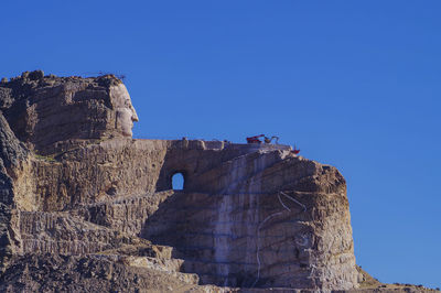 Low angle view of rock formation against blue sky