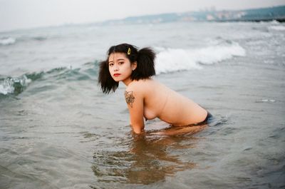 Portrait of beautiful young woman on beach