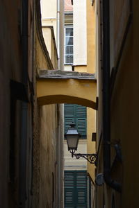 Low angle view of street light against building