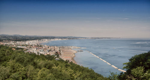 High angle view of sea and city against sky