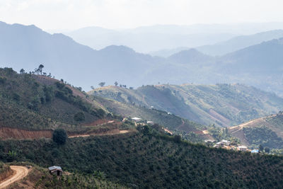 Scenic view of field and mountains against sky