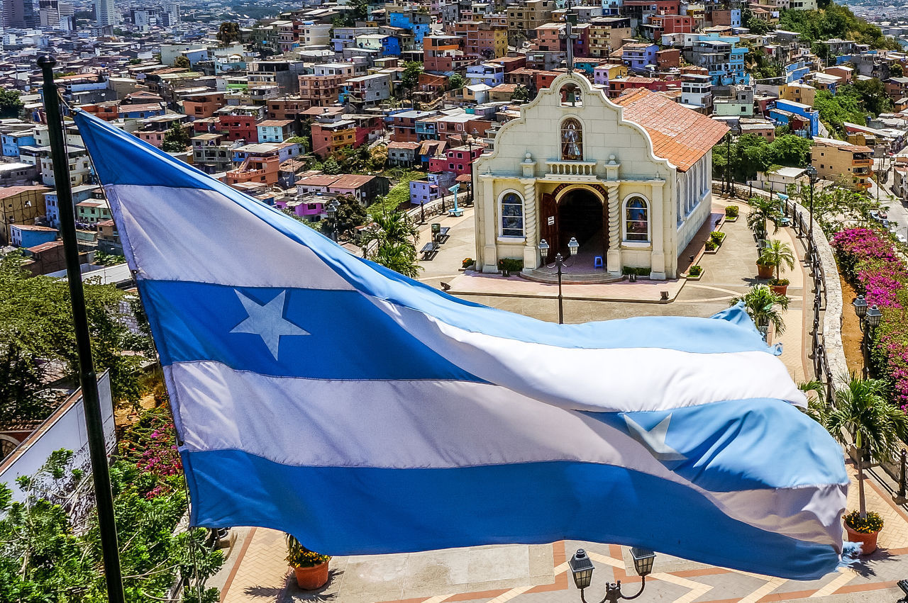 LOW ANGLE VIEW OF FLAG AGAINST BUILDINGS IN CITY