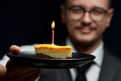 Close-up of hand holding cake