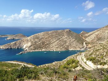 Scenic view of sea and mountains against sky