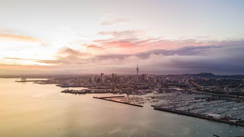 Aerial view of auckland city waterfrontagainst cloudy sky