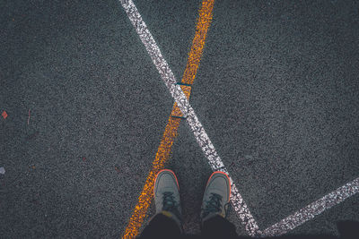 Low section of person standing on street