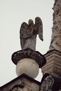 Low angle view of angel statue against clear sky