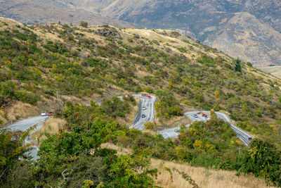 High angle view of road amidst trees and mountains