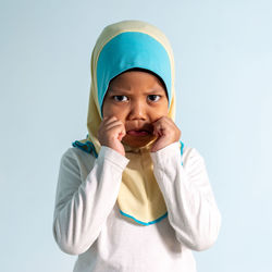 Portrait of cute boy against white background