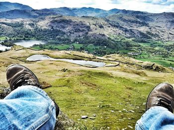 Low section of man standing on field