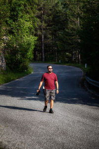 Mountain hiker photographer explores the area for the photographic hunting of wild animals.