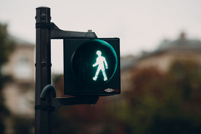 Close-up of road sign against blurred background
