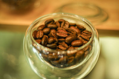 Close-up of coffee beans in glass jar on table