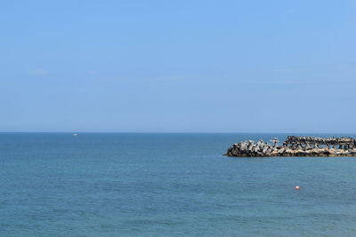 Scenic view of sea against clear blue sky