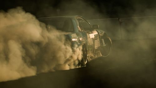 Sport car squealing tires in motor racing event