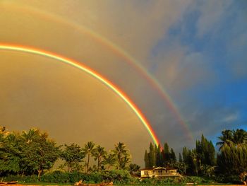 Low angle view of rainbow against sky at sunset