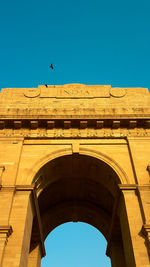 Low angle view of historical building against clear blue sky